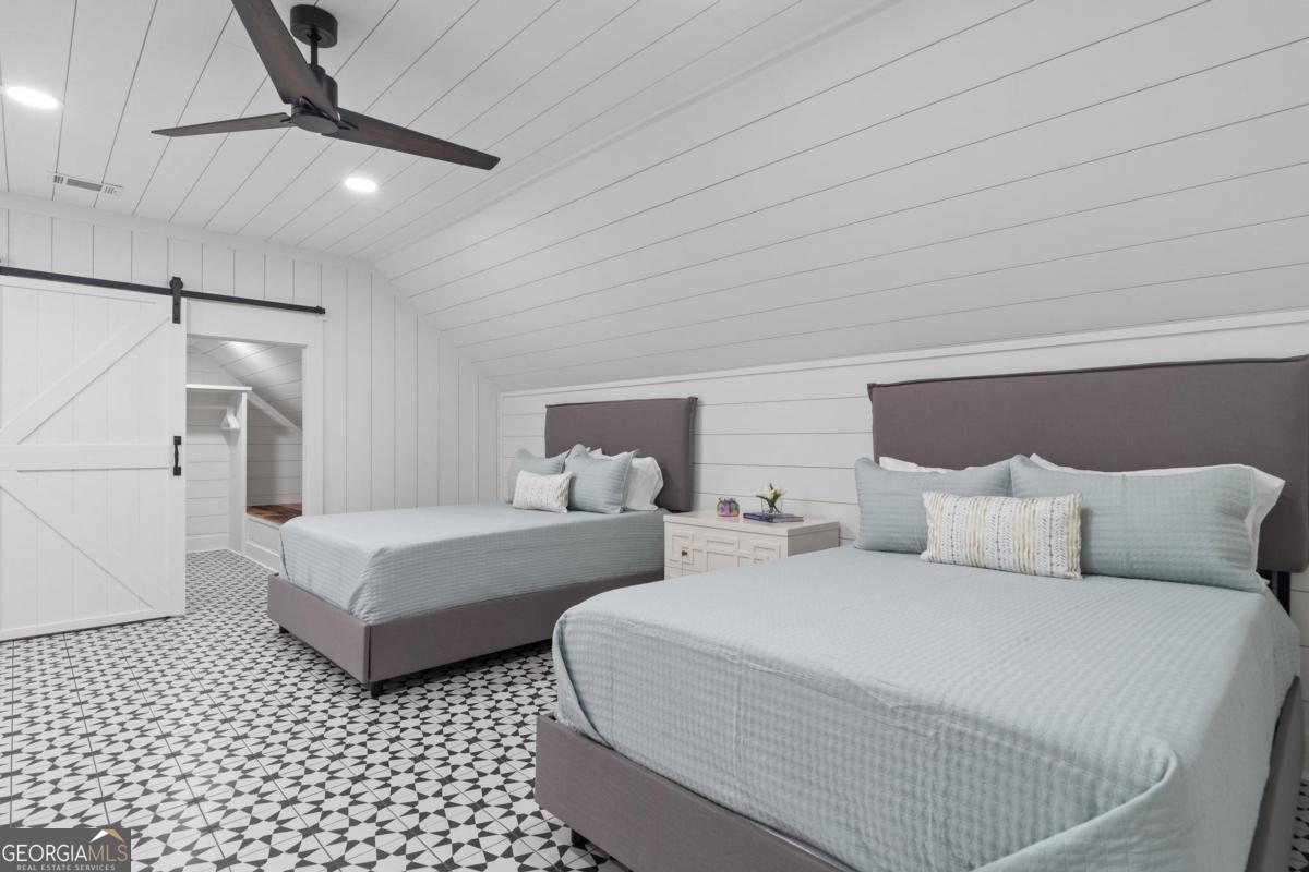 4096 Big Water E Road Sparta, GA 31087 - Photo 45 of 70 a bedroom with two beds and a ceiling fan