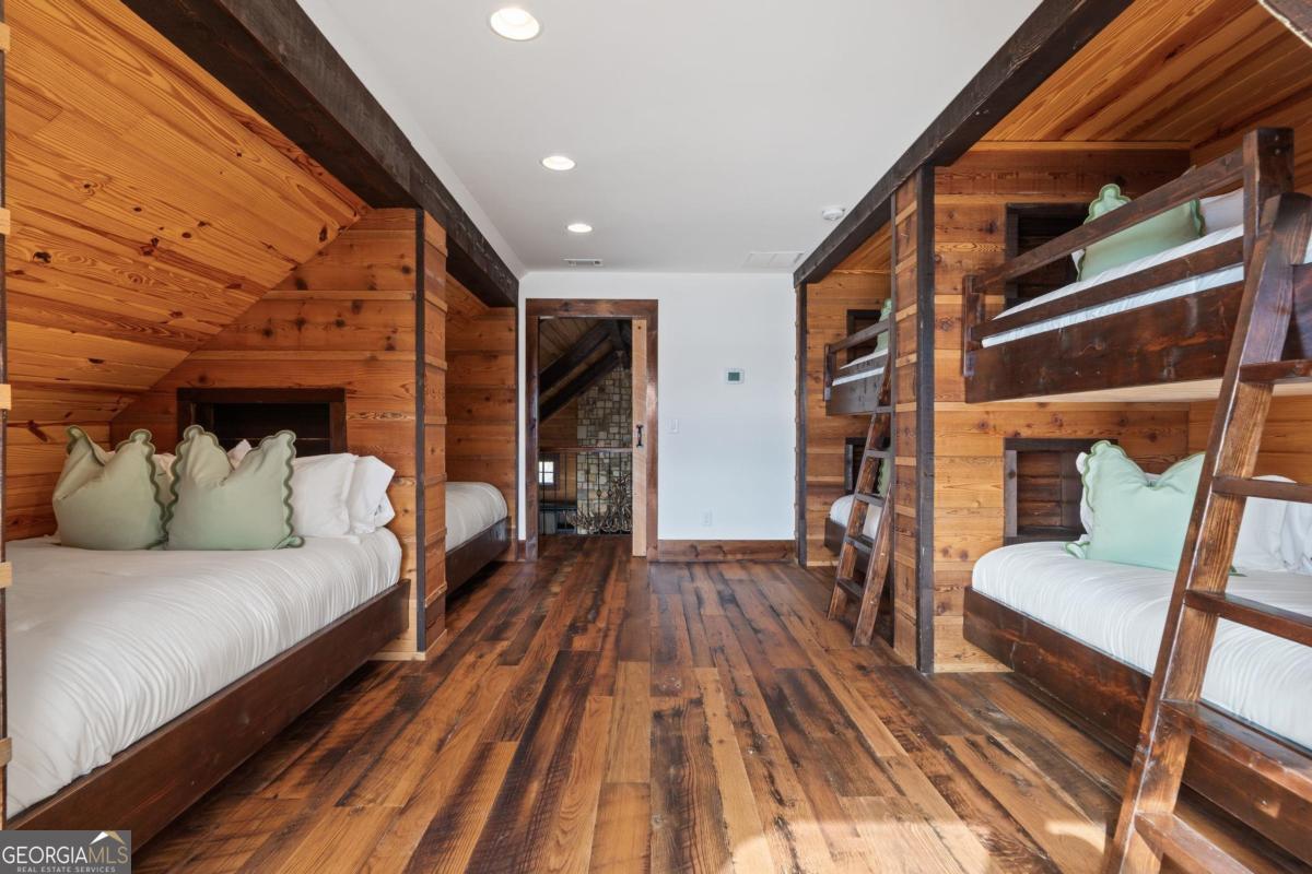 4096 Big Water E Road Sparta, GA 31087 - Photo 54 of 70 a spacious bedroom with a bed and wooden floor