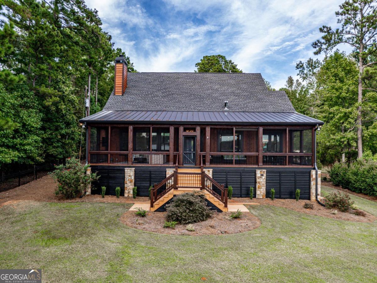 4096 Big Water E Road Sparta, GA 31087 - Photo 57 of 70 a front view of a house with a yard and garage