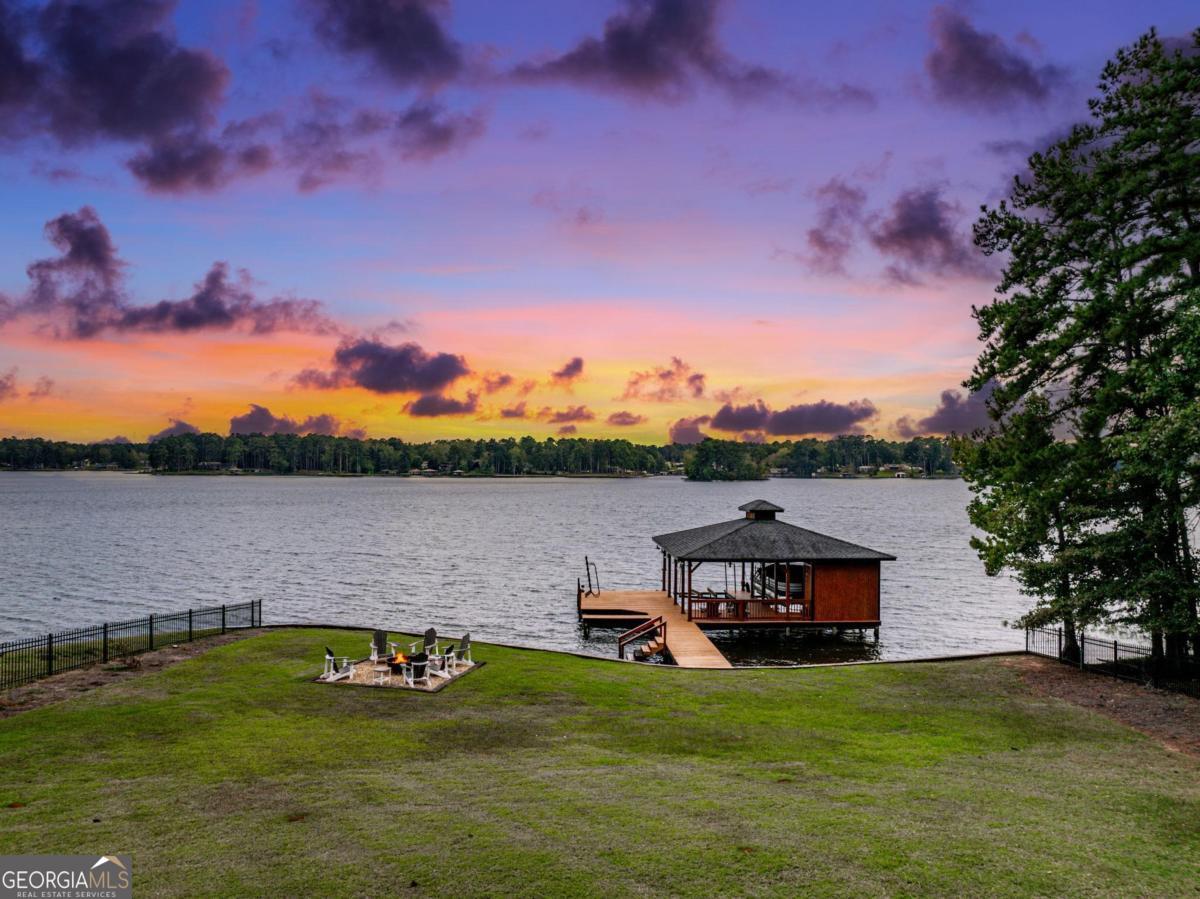 4096 Big Water E Road Sparta, GA 31087 - Photo 6 of 70 a view of a lake with a car parked in the background