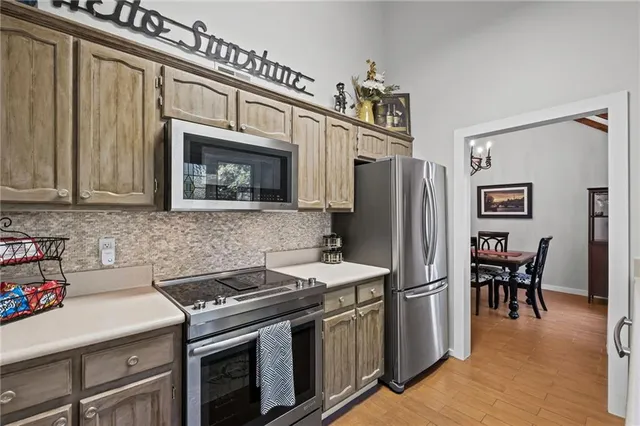 a kitchen with stainless steel appliances a stove a sink and a refrigerator