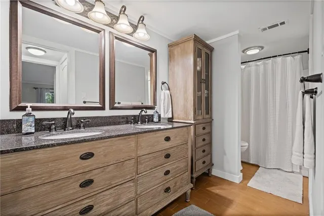 a bathroom with a double vanity sink and a mirror