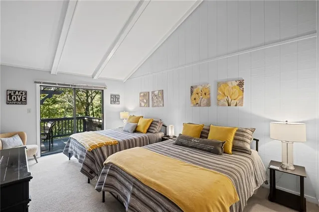 a bedroom with two beds and a large window