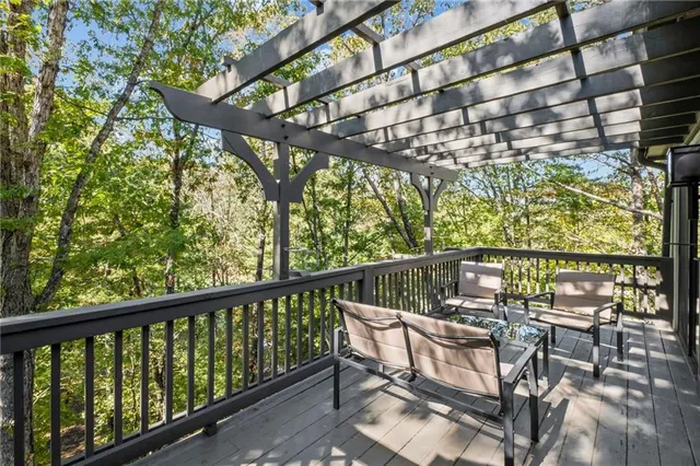 a view of two chairs and table in the balcony