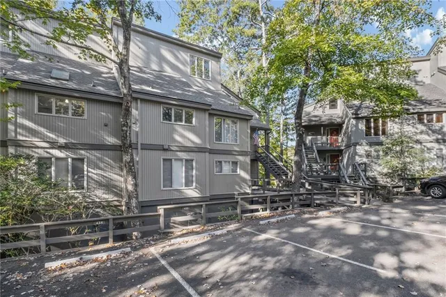 a front view of a house with a tree