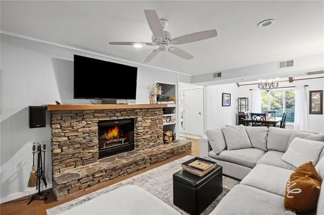 a living room with furniture a fireplace and a flat screen tv