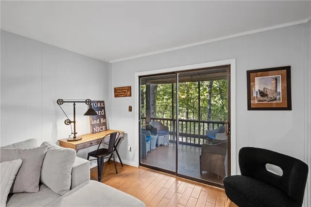 a living room with furniture and a floor to ceiling window