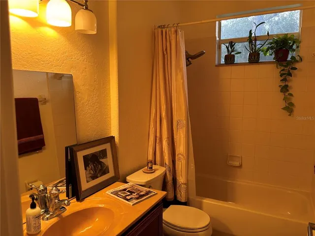 a bedroom with a bed and a desk