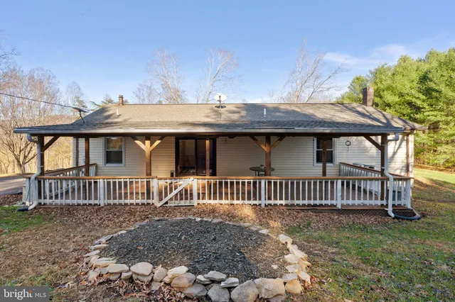a view of a patio with table and chairs under an umbrella