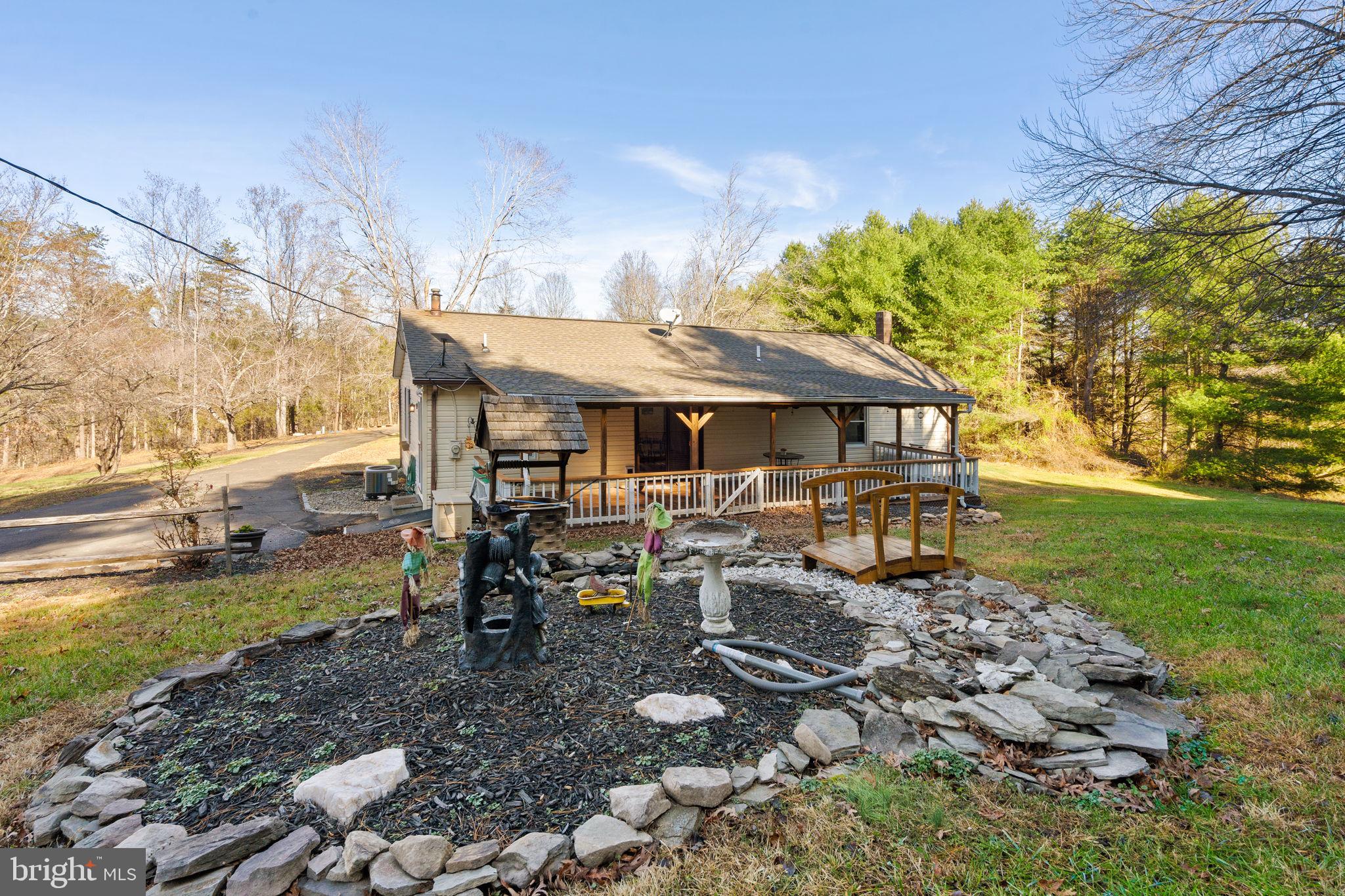 148 Viewtown Road Amissville, VA 20106 - Photo 17 of 56 a view of a patio with table and chairs under an umbrella