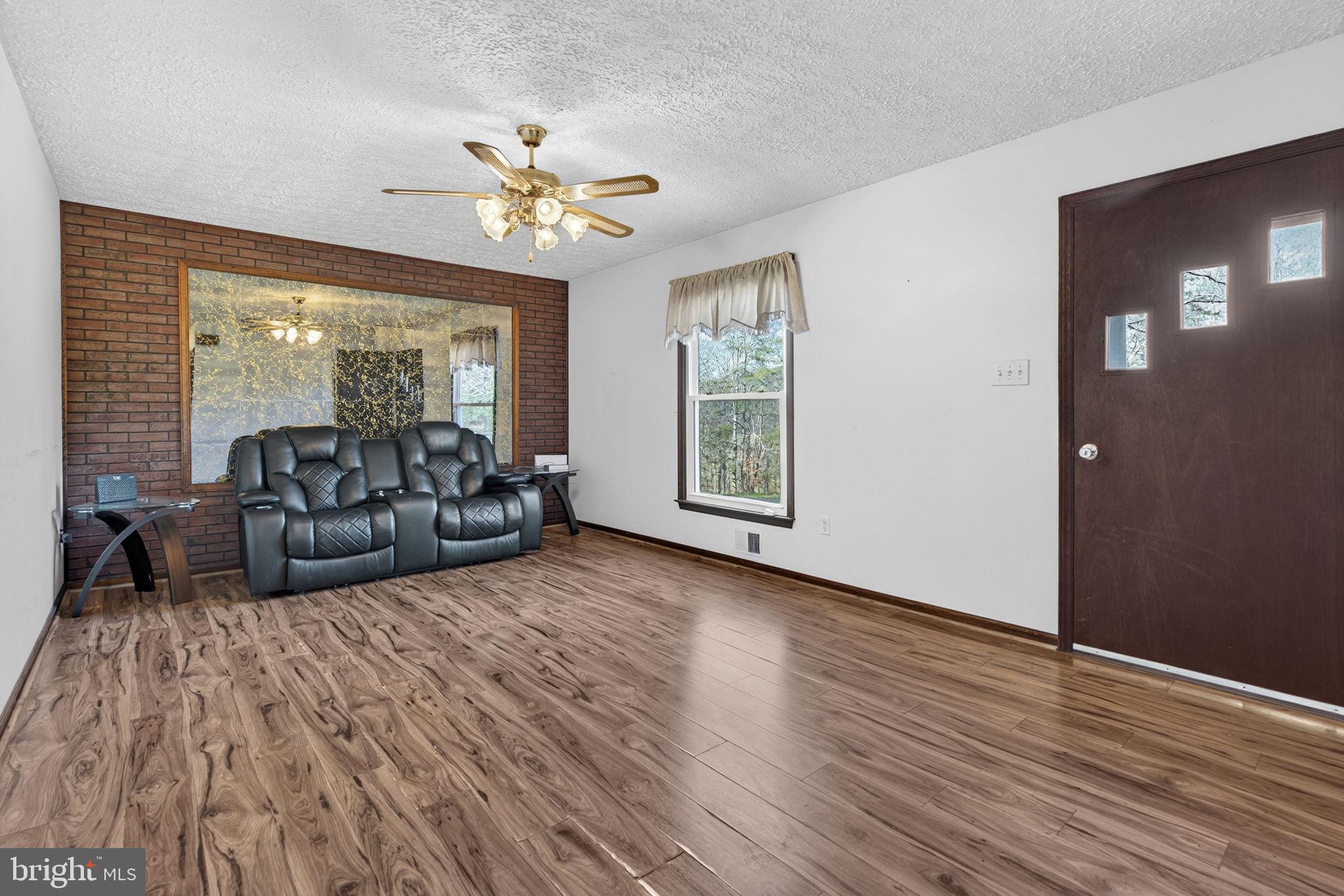 148 Viewtown Road Amissville, VA 20106 - Photo 32 of 56 a living room with furniture and a large window