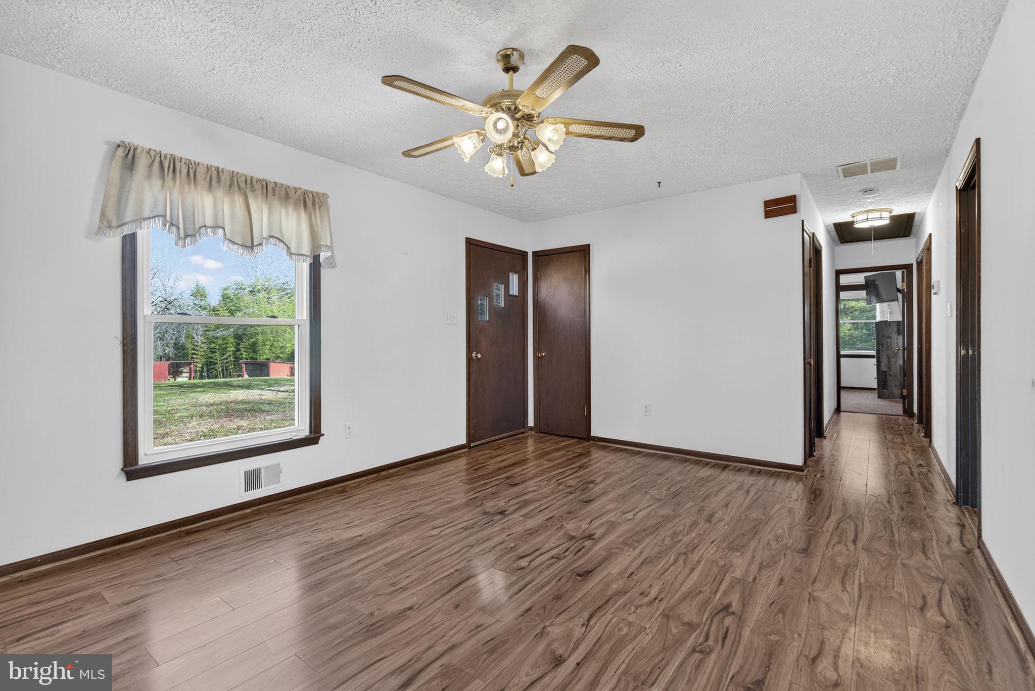 148 Viewtown Road Amissville, VA 20106 - Photo 33 of 56 a view of an empty room with wooden floor and a window