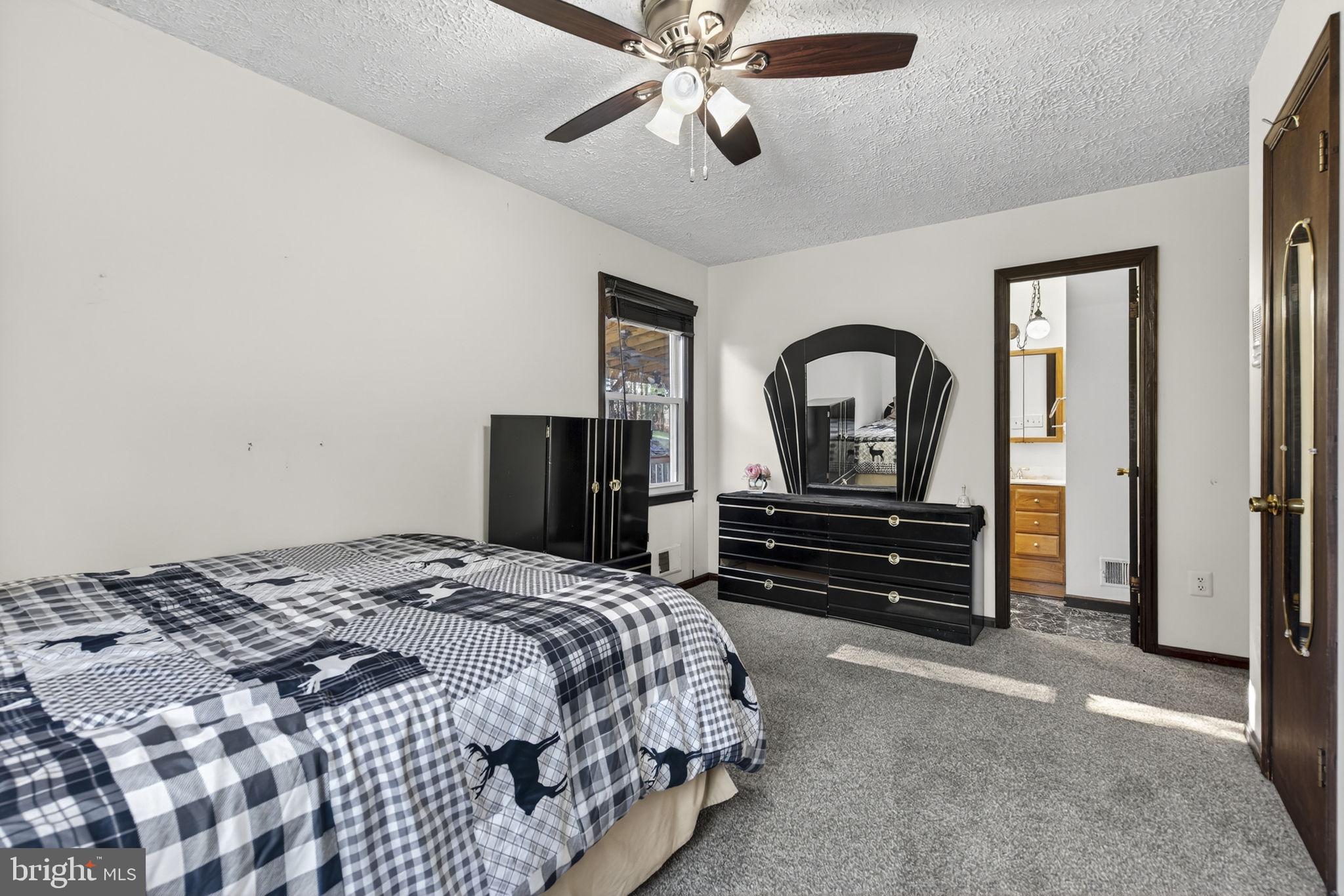 148 Viewtown Road Amissville, VA 20106 - Photo 41 of 56 a bedroom with a bed and a chandelier