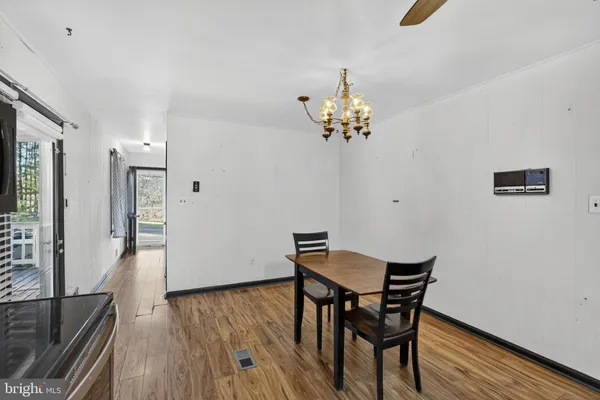 a view of a hallway with wooden floor and closet