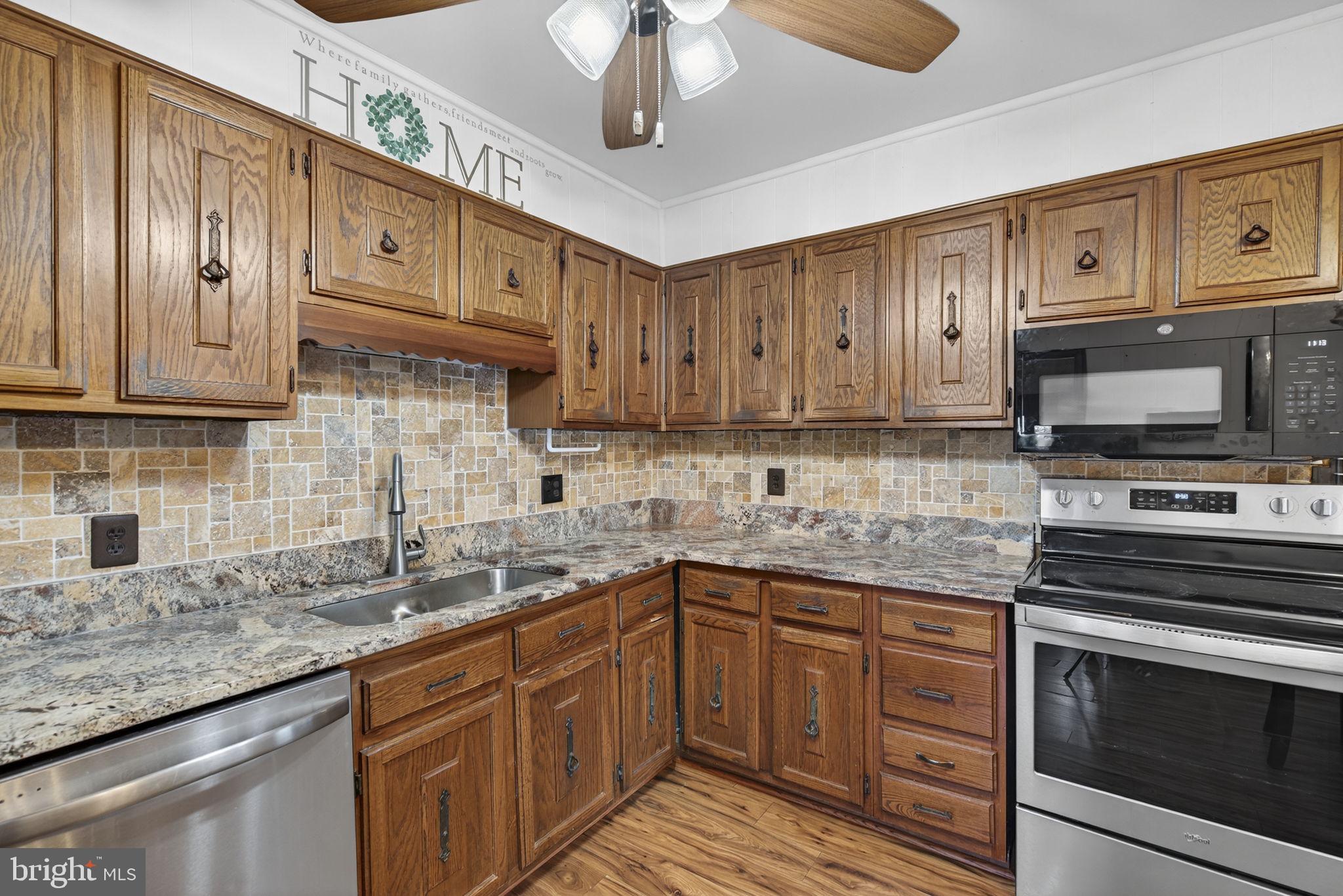 148 Viewtown Road Amissville, VA 20106 - Photo 46 of 56 a kitchen with stainless steel appliances granite countertop a sink a stove cabinets and wooden floor