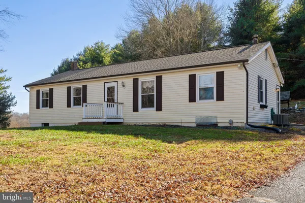 a view of house with outdoor space and garden