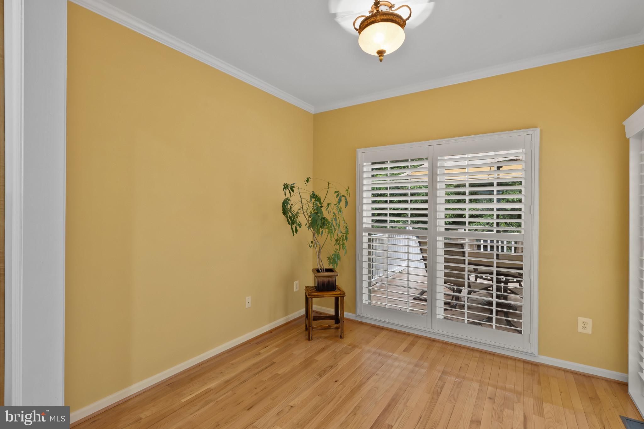 2433 Killarney Terrace Odenton, MD 21113 - Photo 15 of 48 a view of an empty room with a window and wooden floor
