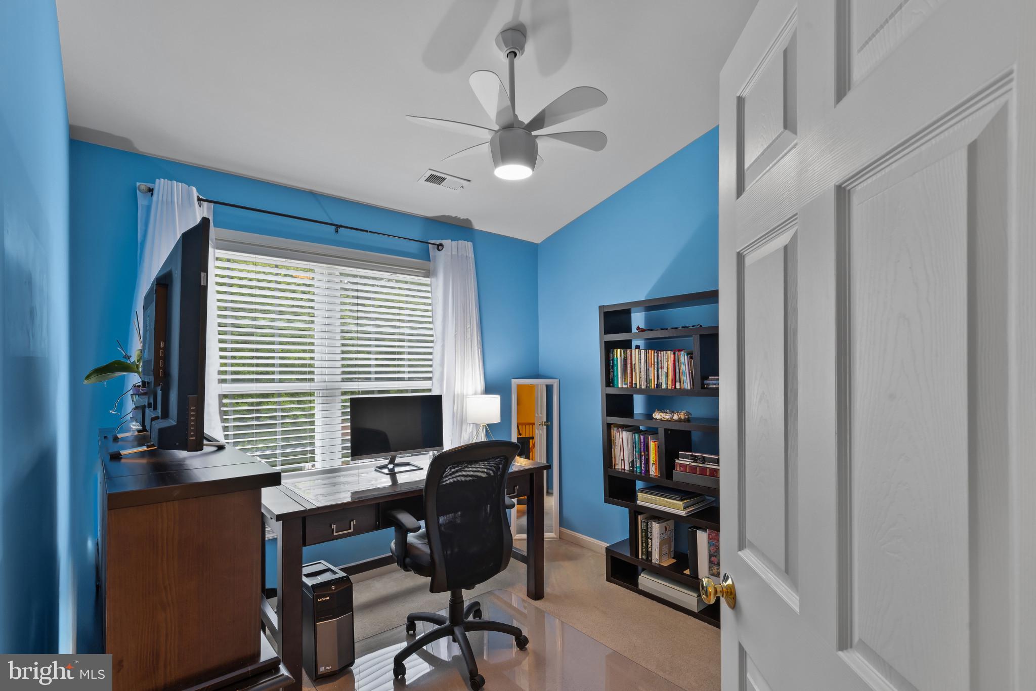 2433 Killarney Terrace Odenton, MD 21113 - Photo 28 of 48 a view of a workspace with furniture and a bookshelf