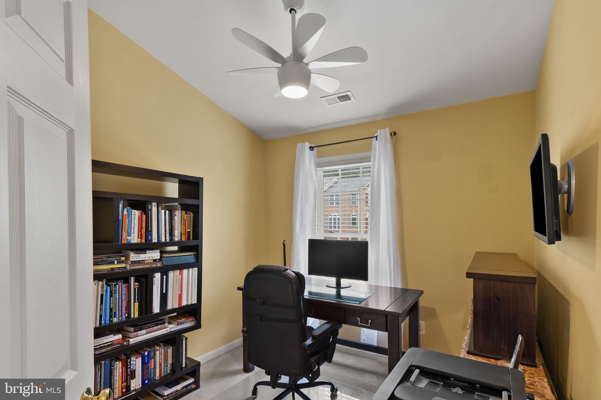 2433 Killarney Terrace Odenton, MD 21113 - Photo 30 of 48 a view of a workspace with furniture and a bookshelf