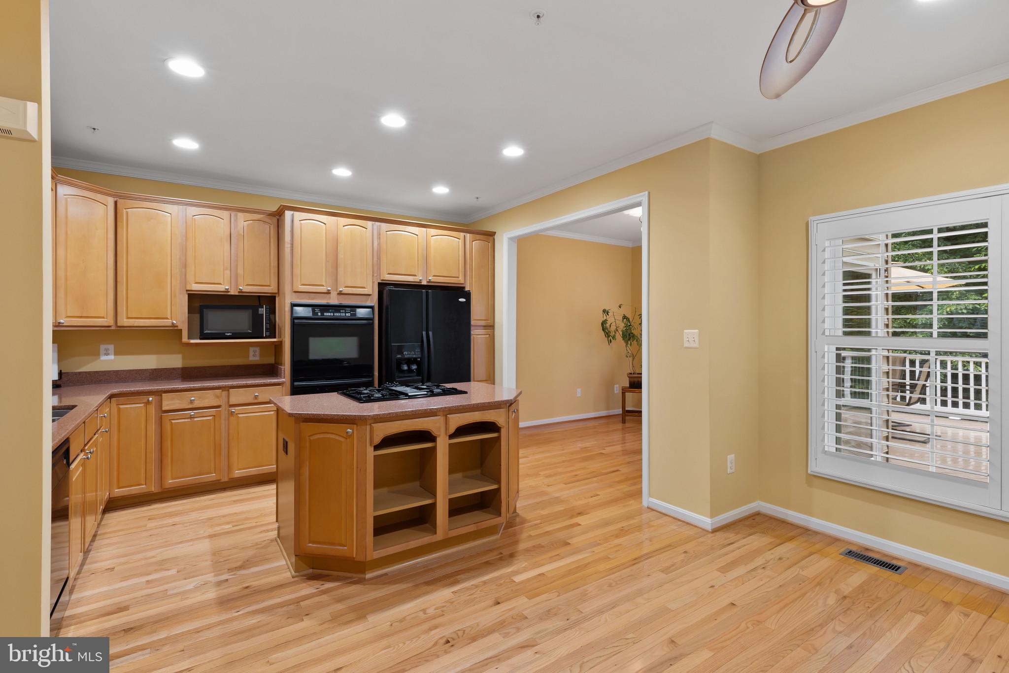 2433 Killarney Terrace Odenton, MD 21113 - Photo 7 of 48 a view of kitchen with stainless steel appliances wooden floor and large window