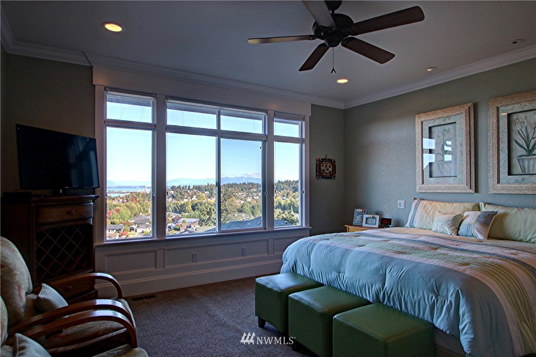 3907 Ridgetop Anacortes, WA 98221 - Photo 12 of 23 a bedroom with a bed a couch and a flat tv