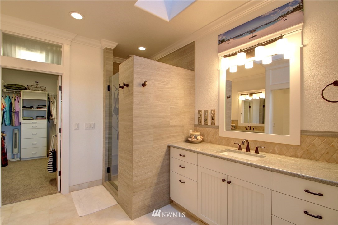3907 Ridgetop Anacortes, WA 98221 - Photo 13 of 23 a bathroom with a shower sink and mirror