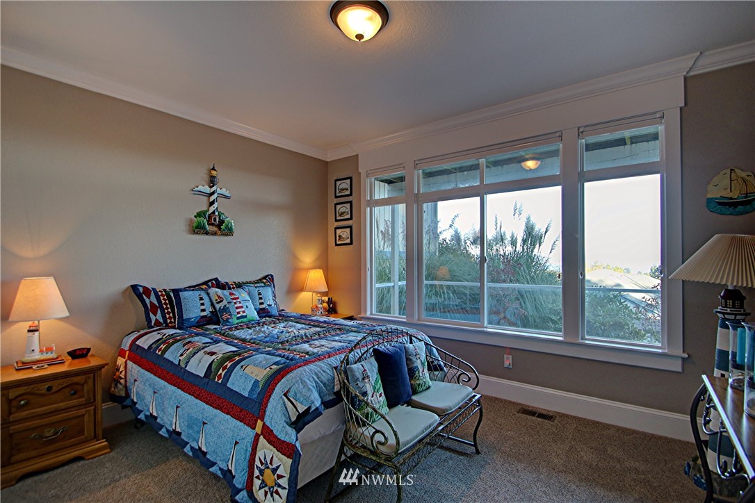 3907 Ridgetop Anacortes, WA 98221 - Photo 18 of 23 a bedroom with a bed and a lamp on dresser