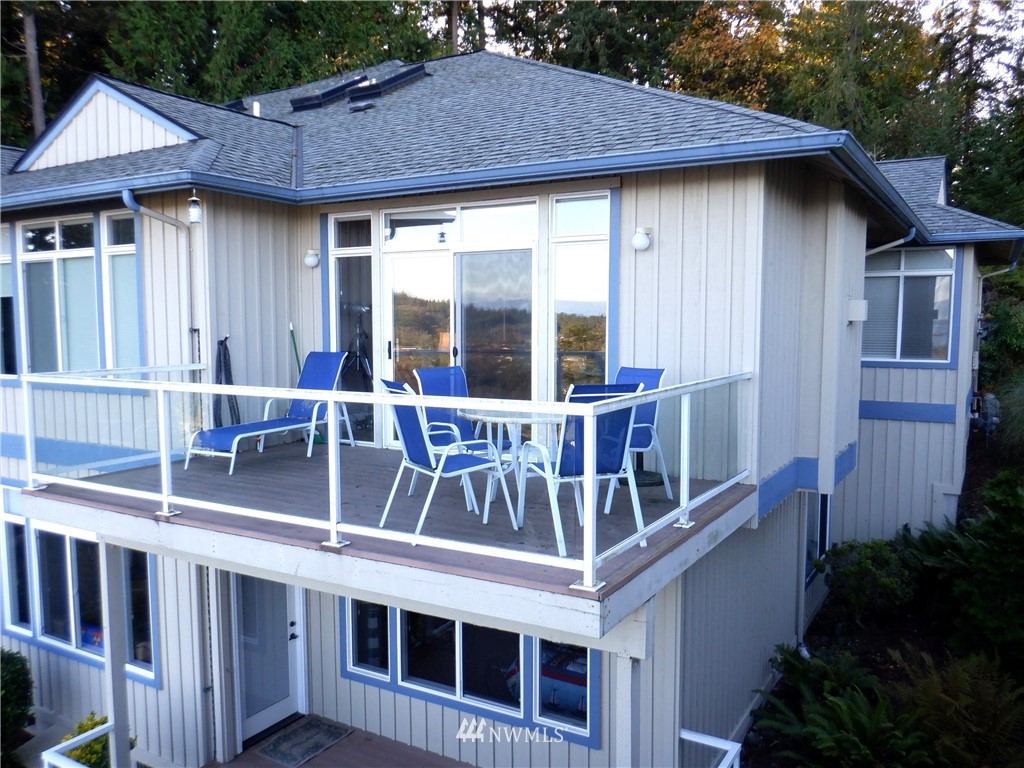 3907 Ridgetop Anacortes, WA 98221 - Photo 20 of 23 a view of a house with large windows and a small yard
