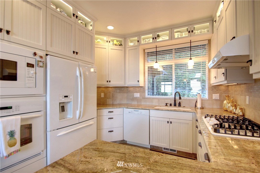 3907 Ridgetop Anacortes, WA 98221 - Photo 5 of 23 a kitchen with stainless steel appliances a refrigerator sink and cabinets