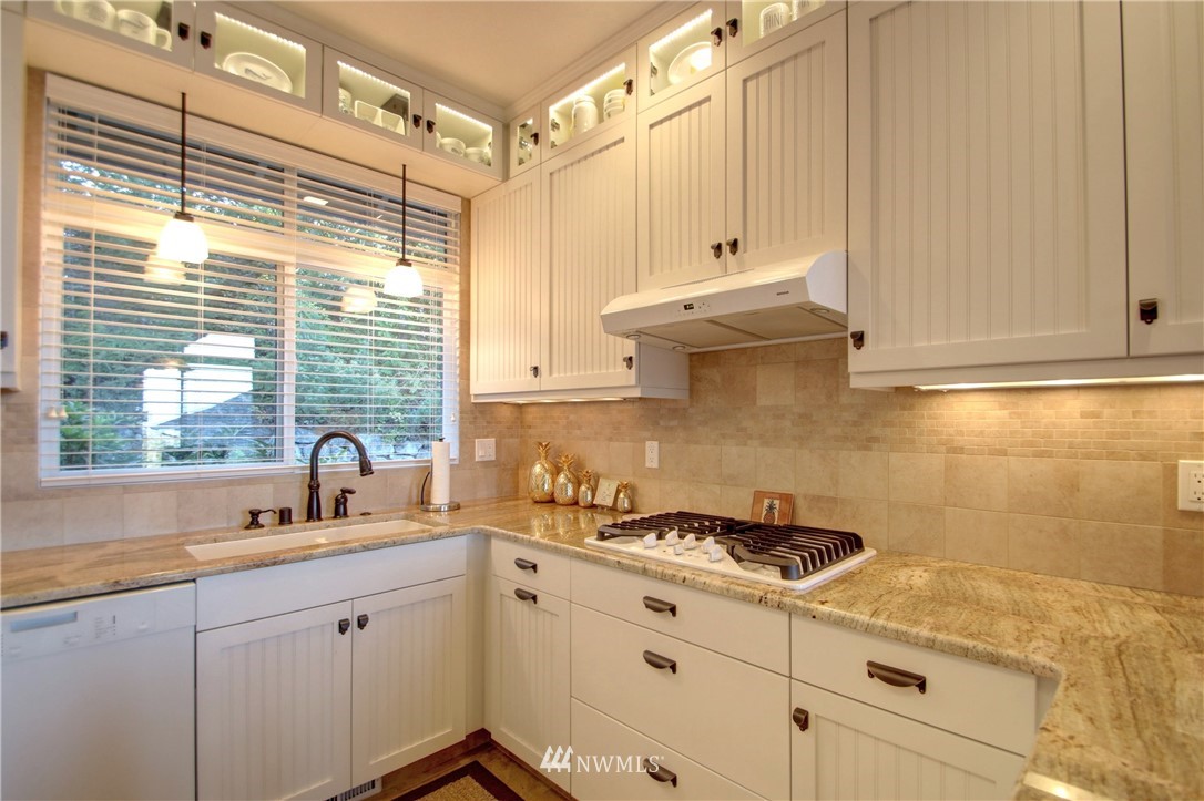 3907 Ridgetop Anacortes, WA 98221 - Photo 6 of 23 a kitchen with granite countertop a sink a stove and cabinets
