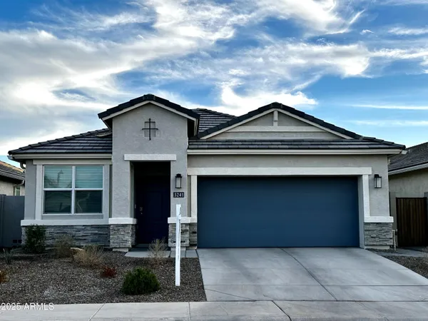 a front view of a house with a garden