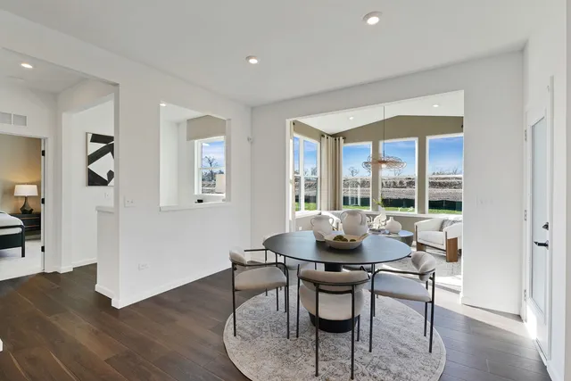a dining room with furniture and wooden floor