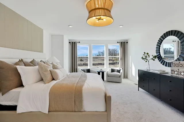 a bedroom with bed and a large window