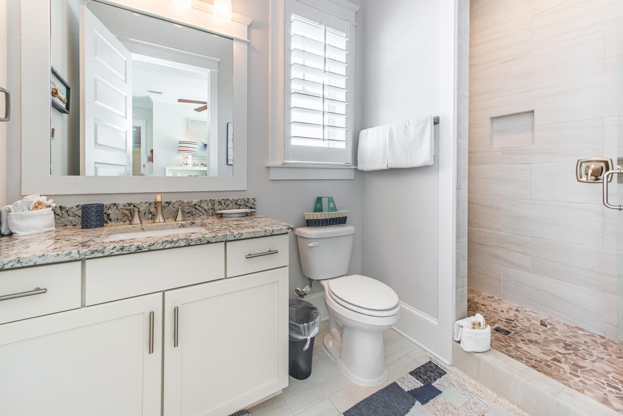 9 West Chester St Inlet Beach Inlet Beach, FL 32461 - Photo 24 of 54 a bathroom with a granite countertop toilet sink and mirror