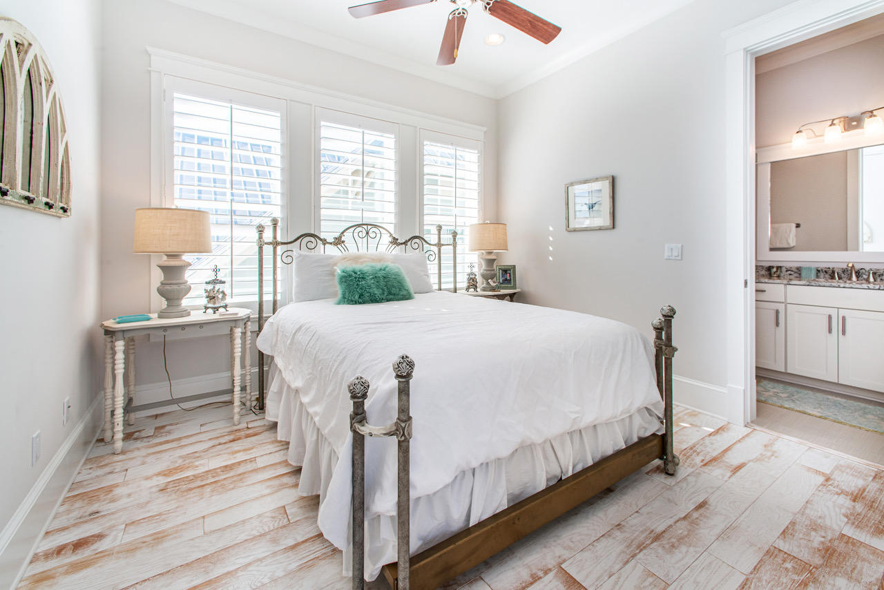 9 West Chester St Inlet Beach Inlet Beach, FL 32461 - Photo 25 of 54 a bedroom with a large bed and a chandelier