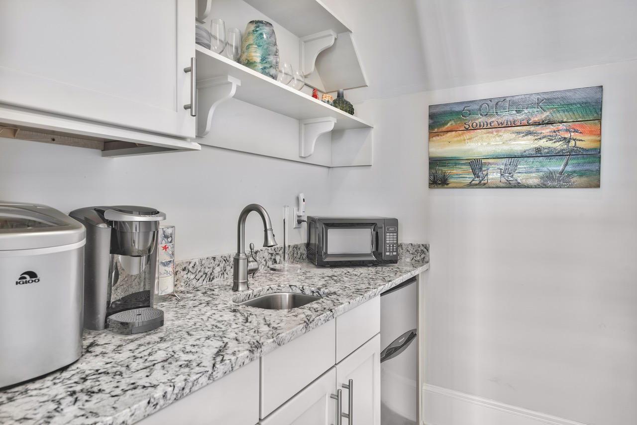 9 West Chester St Inlet Beach Inlet Beach, FL 32461 - Photo 29 of 54 a kitchen with stainless steel appliances granite countertop a sink and a wooden floor