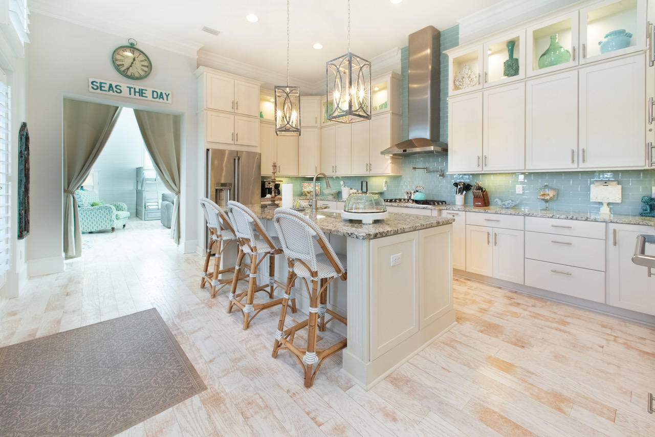 9 West Chester St Inlet Beach Inlet Beach, FL 32461 - Photo 5 of 54 a kitchen with stainless steel appliances granite countertop a stove a sink dishwasher and a dining table with cabinets