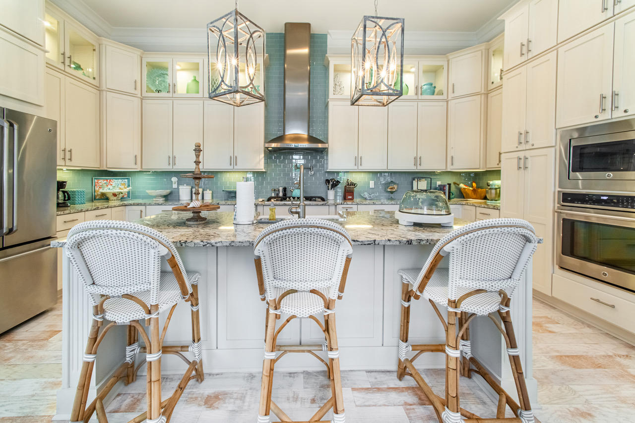 9 West Chester St Inlet Beach Inlet Beach, FL 32461 - Photo 6 of 54 a kitchen with stainless steel appliances granite countertop a table chairs stove a sink dishwasher and cabinets with wooden floor