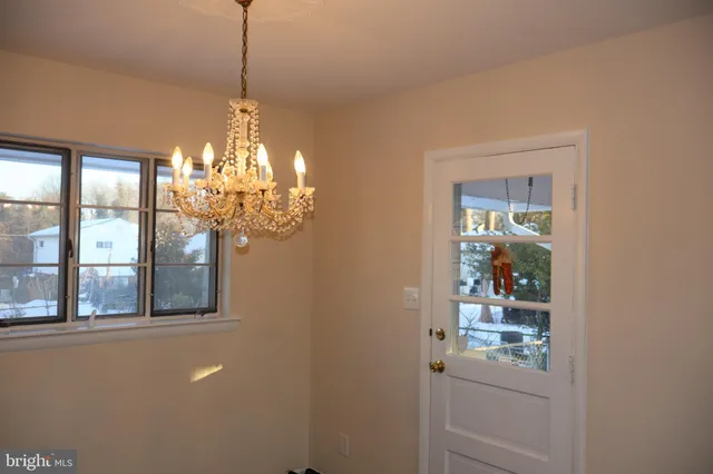 a dining room with chandelier and window