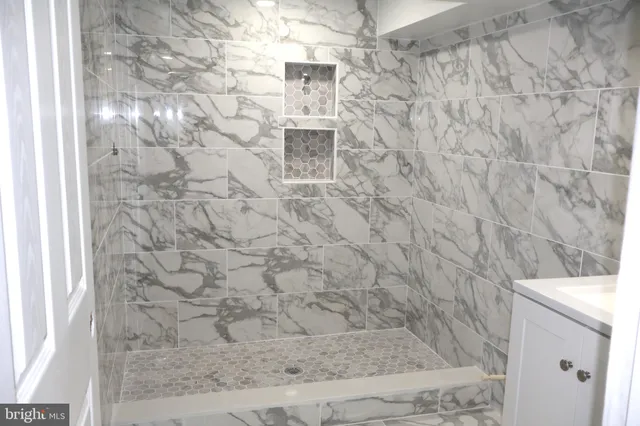 a bathroom with a shower and a glass door