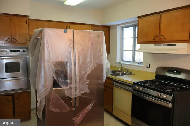 a kitchen with stainless steel appliances granite countertop a stove a refrigerator and a microwave