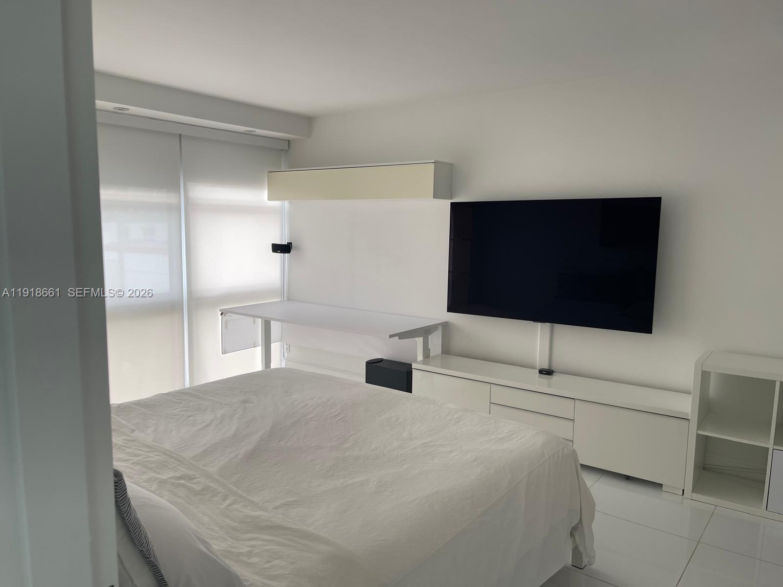 16909 North Bay Road, Unit 716 Sunny Isles Beach, FL 33160 - Photo 12 of 26 a bedroom with a bed and a flat screen tv