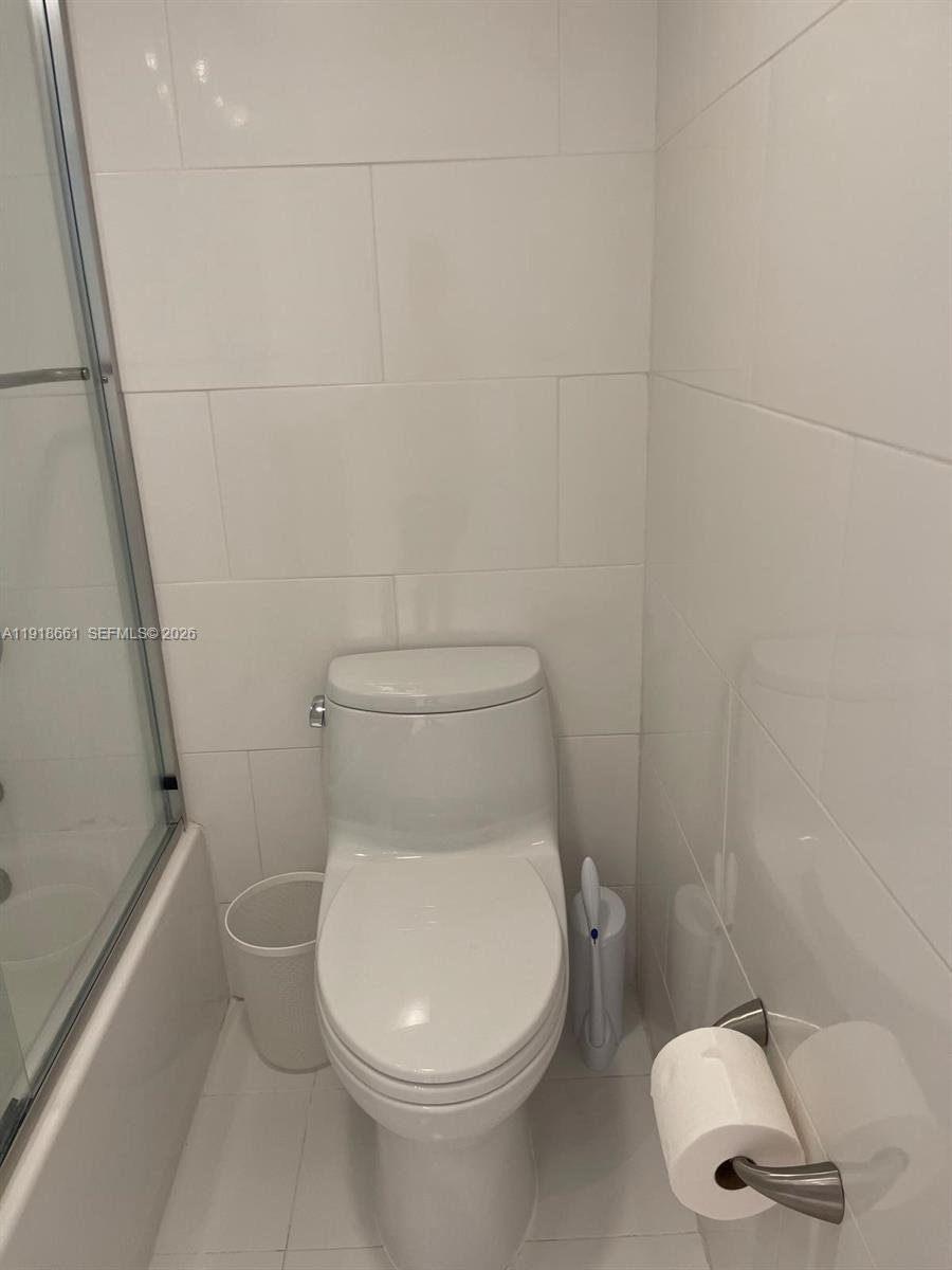 16909 North Bay Road, Unit 716 Sunny Isles Beach, FL 33160 - Photo 20 of 26 a white toilet sitting next to a white sink