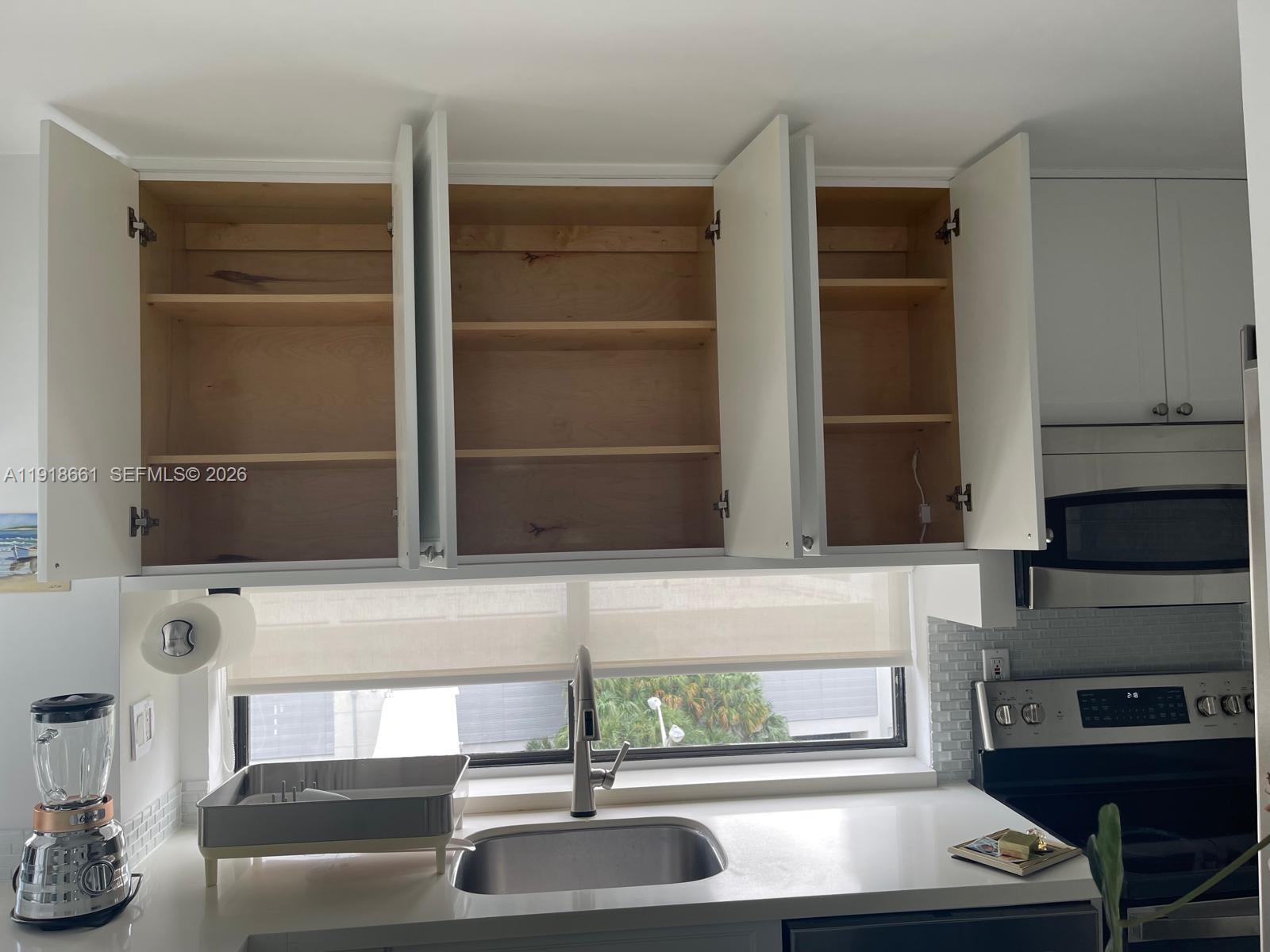 16909 North Bay Road, Unit 716 Sunny Isles Beach, FL 33160 - Photo 21 of 26 a kitchen with a sink and a stove top oven