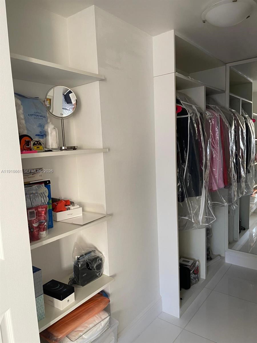 16909 North Bay Road, Unit 716 Sunny Isles Beach, FL 33160 - Photo 25 of 26 a view of walk in closet with clothes and shoes