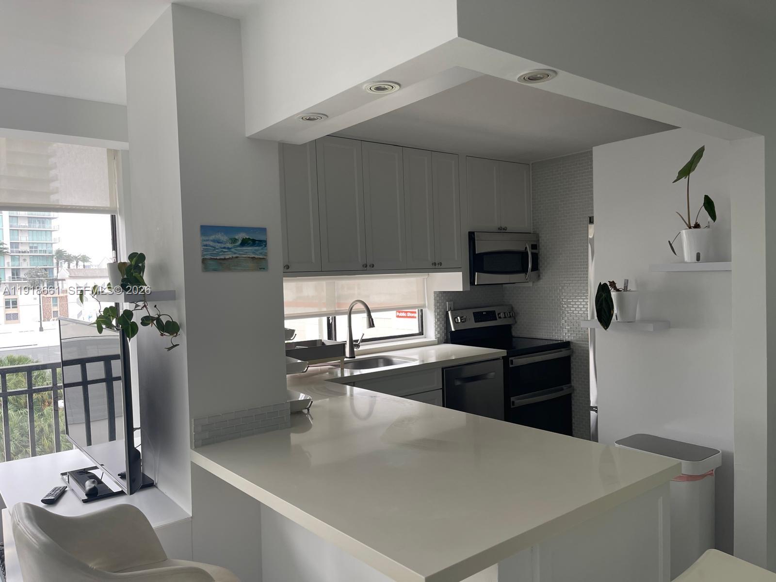 16909 North Bay Road, Unit 716 Sunny Isles Beach, FL 33160 - Photo 26 of 26 a kitchen with stainless steel appliances granite countertop a sink dishwasher stove top oven and refrigerator