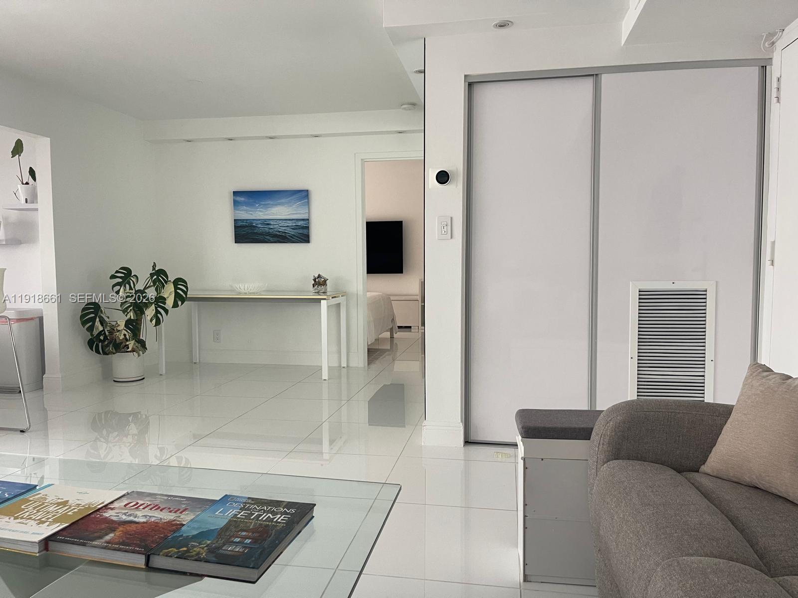 16909 North Bay Road, Unit 716 Sunny Isles Beach, FL 33160 - Photo 8 of 26 a living room with furniture and a potted plant