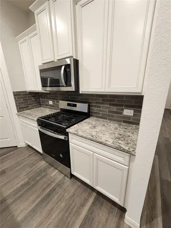 a kitchen with wooden cabinets and a stove top oven