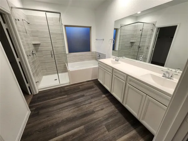 a bathroom with a bathtub and a sink