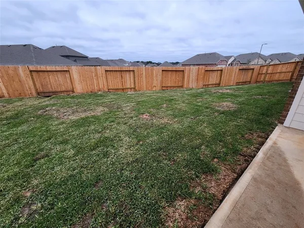 an outdoor view of house with backyard and green space